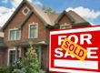 Beautiful home with for sale sign in foreground