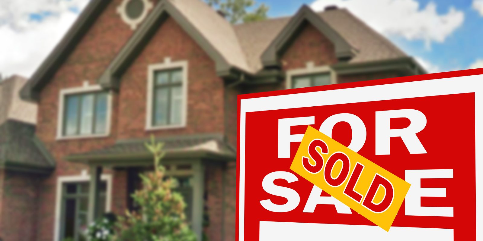 Beautiful home with for sale sign in foreground